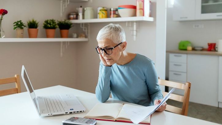 A woman reviews her estimated Social Security benefits on her laptop. 