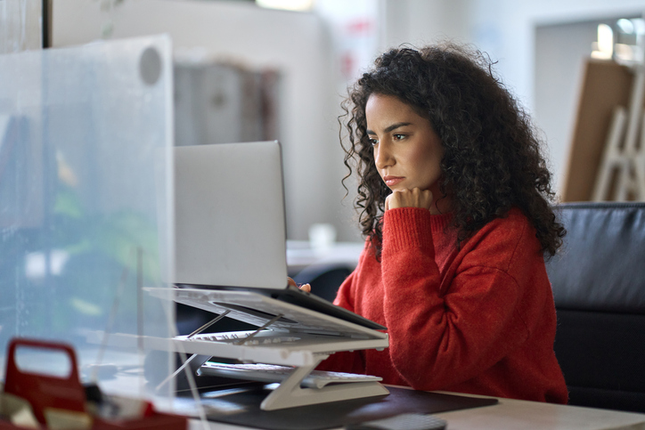 A woman researching IRS requirements for educational tax credits.