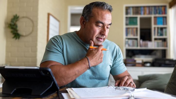 A man reviews his financial records as he files his taxes.