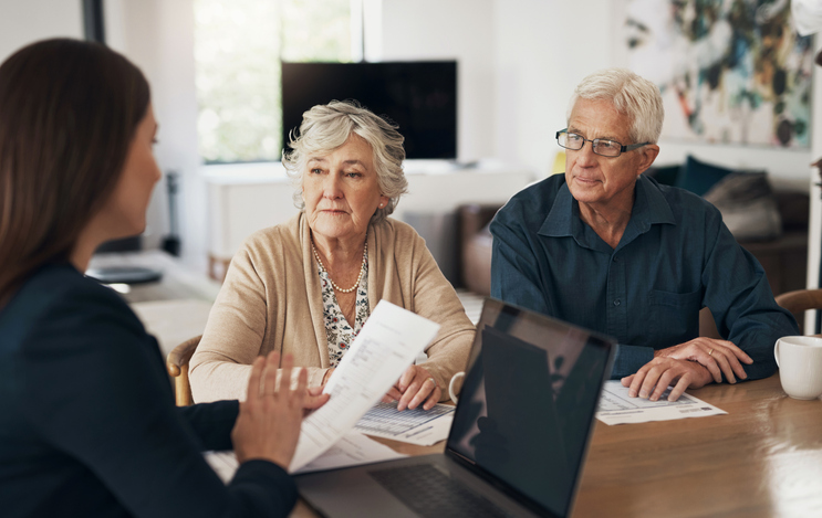 Retirees meeting with a financial advisor to discuss their retirement plan.