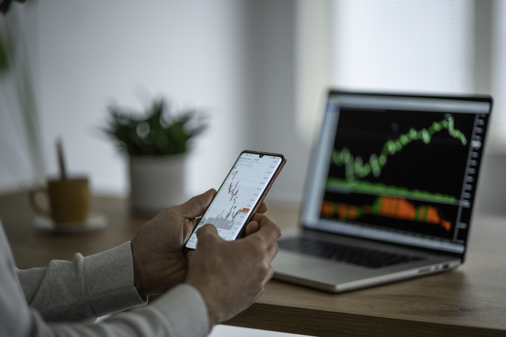 Closeup of an investor tracking the performance of a portfolio.
