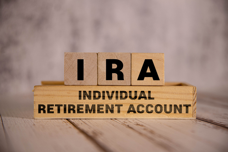 Light wooden blocks and cubes with the text "IRA Individual Retirement Account."