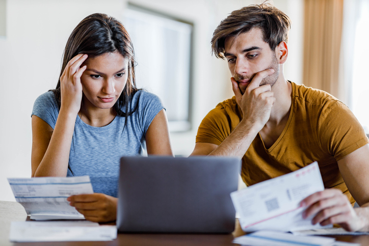 Homeowners reviewing paperwork for a 401(k) loan.